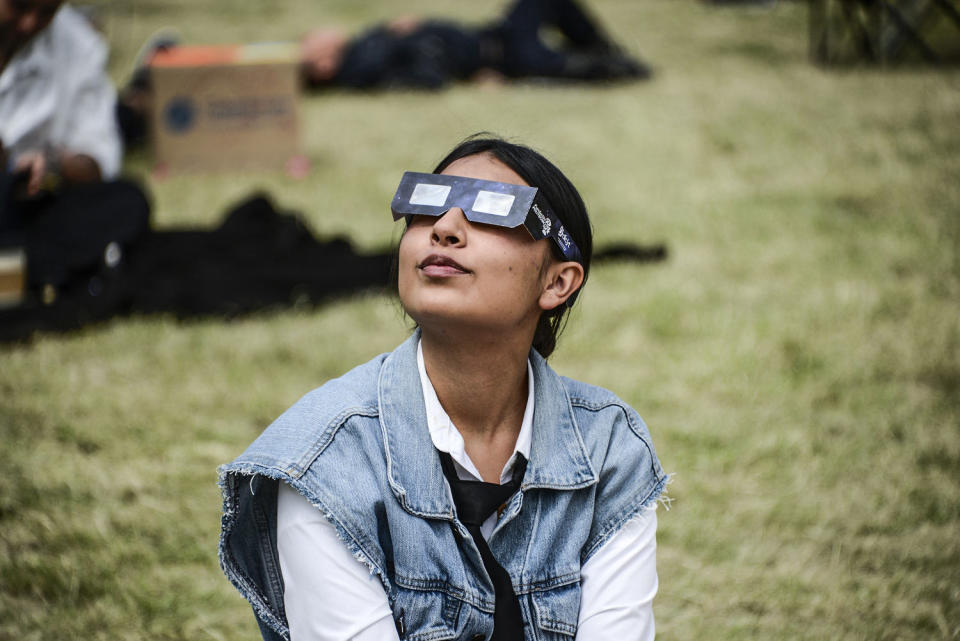 A woman watches the Annular Solar Eclipse with special sun filter glasses (Carlos Tischler / Future Publishing via Getty Images file)