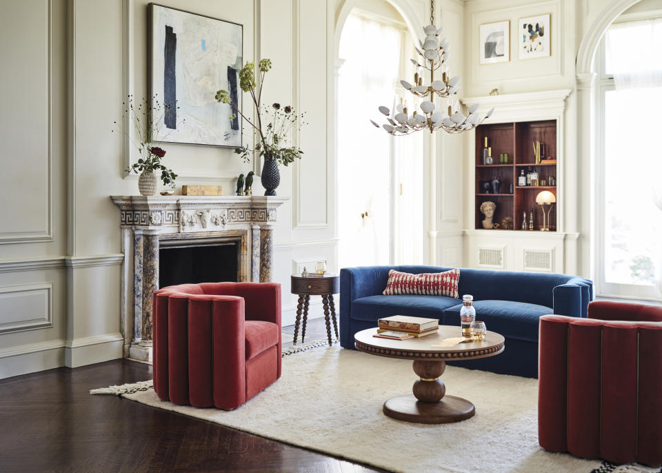 This undated photo shows Anthropologie's Adriana velvet chair. The chair, in a 70s-era rust hue, is a comfy, cushy nod to the groovy décor trend. (Anthropologie via AP)