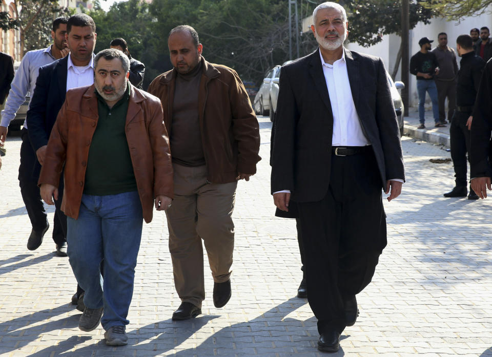 Hamas' supreme leader Ismail Haniyeh, center right, tours destroyed buildings, in Gaza City, Wednesday, March 27, 2019. Haniyeh made his first public appearance since a new round of cross-border violence with Israel this week. On Wednesday he visited the rubble of his Gaza City office, which was destroyed in an Israeli airstrike. (AP Photo/Adel Hana)