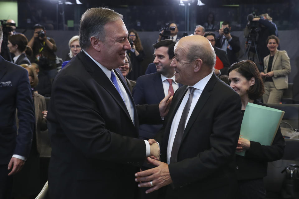 U.S. Secretary of State Mike Pompeo, left, shakes hands with France's Foreign Minister Jean-Yves Le Drian during a NATO Foreign Ministers meeting at the NATO headquarters in Brussels, Wednesday, Nov. 20, 2019. (AP Photo/Francisco Seco)
