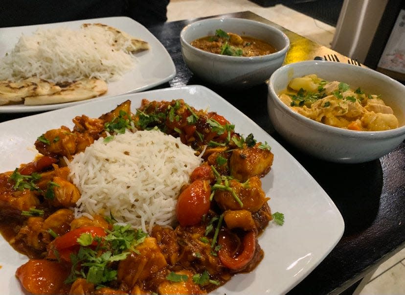 This Indian Chinese inspired entree is a sweet and spicy stir fry with bell peppers, onions and chicken sautéed in fresh ginger and garlic with scallions and cilantro, served beside a bed of rice.