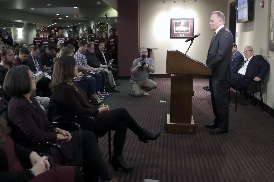 Bobby Petrino speaks after being introduced as the new NCAA college football head coach at Missouri State as his wife Becky, seated second from left, listens during a news conference Thursday, Jan. 16, 2020, in Springfield, Mo. Petrino has a 119-56 record in 14 seasons at Arkansas, Western Kentucky and Louisville and replaces Dave Steckel who was fired after winning just 13 games in five seasons. (AP Photo/Jeff Roberson)