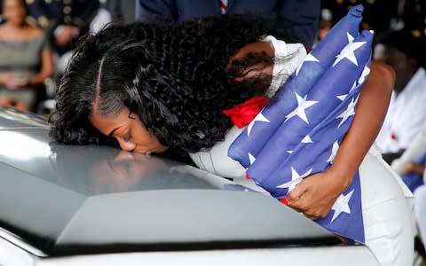 Myeshia Johnson, wife of U.S. Army Sergeant La David Johns, kisses his coffin at a graveside service in Hollywood - Credit: JOE SKIPPER/Reuters 