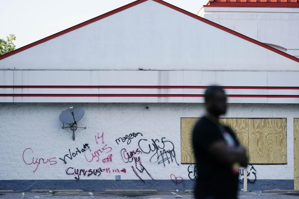 A person stands across from the shuttered Xpress Mart Shell station during a prayer vigil, Friday, June 2, 2023, in Columbia, S.C. Cyrus Carmack-Belton, a 14-year-old boy will be laid to rest less than one week after officials say a South Carolina gas station owner gunned him down in a killing that has prompted cries of racial profiling.(AP Photo/Erik Verduzco)