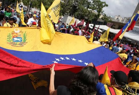 Opposition supporters carry a Venezuelan flags along the streets as they part in a rally to demand a referendum to remove Venezuela's President Nicolas Maduro, in Caracas, Venezuela, September 16, 2016. REUTERS/Stringer