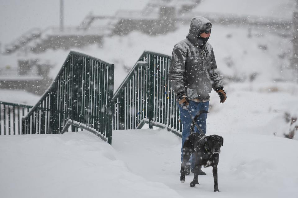 A man walks his dog on Jan. 10 at Falls Park in Sioux Falls, S.D.