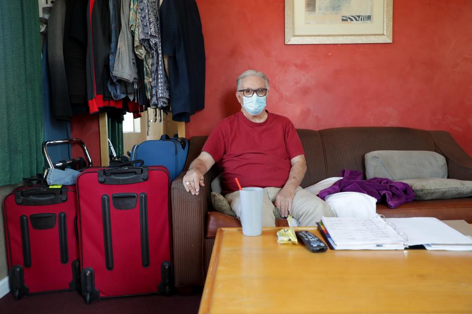 In this 2020 file photo, Lee Fournier sits in his hotel room provided by Project Roomkey at Rodeway Inn & Suites in Indio, Calif. Project Roomkey was an effort by the state to house individuals experiencing homelessness during the COVID-19 pandemic.