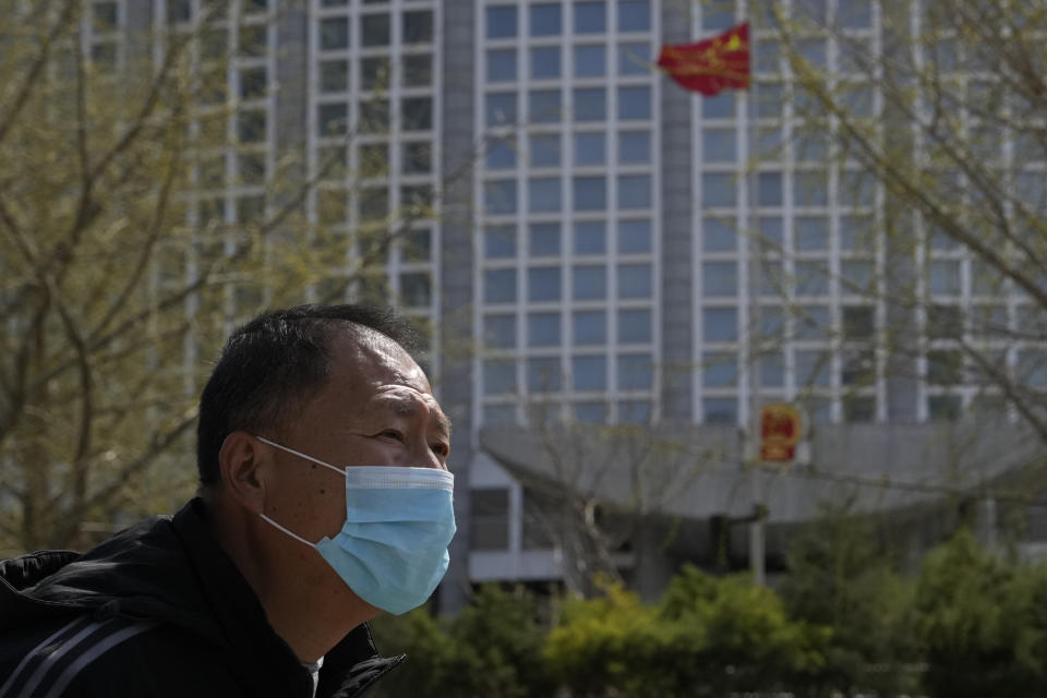 A man wearing a mask walks past the Ministry of Foreign Affairs in Beijing, Sunday, March 26, 2023. Honduras formed diplomatic ties with China on Sunday after breaking off relations with Taiwan, which is now recognized by only 13 sovereign states, including Vatican City. (AP Photo/Ng Han Guan)