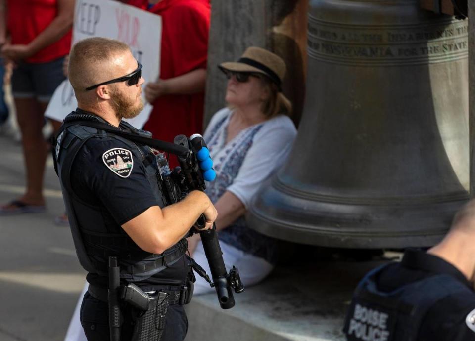 A Boise police officer carries less-lethal sponge rounds while patrolling a pro-life celebration that was met with an abortion rights protest outside of the Idaho Statehouse in Boise on Tuesday, June 28, 2022.