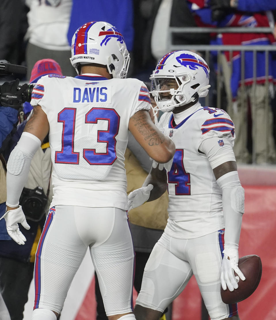 Buffalo Bills wide receiver Stefon Diggs (14) is congratulated by Gabe Davis (13) after his touchdown against the New England Patriots during the first half of an NFL football game, Thursday, Dec. 1, 2022, in Foxborough, Mass. (AP Photo/Steven Senne)