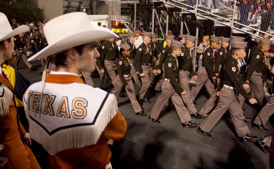 Members of the Texas A&M Corps of Cadets march before the Longhorn Band before the Nov. 24, 2011 Texas-Texas A&M game at Kyle Field in College Station.  This is the last time the two historic rivals will meet in football, but that's all about to change this fall after the Longhorns join the SEC.