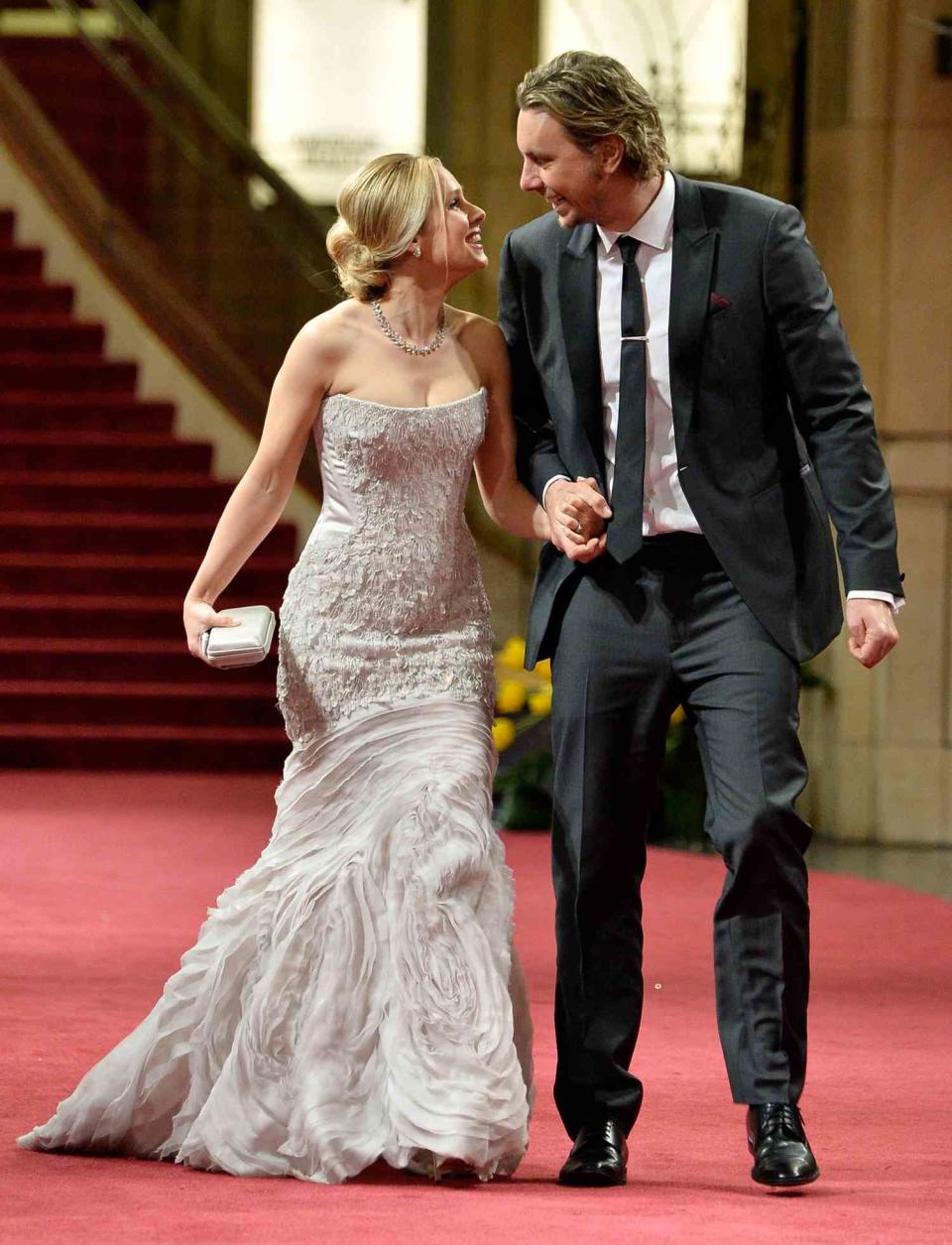 Actors Kristen Bell (L) and Dax Shepard depart the Oscars at Hollywood & Highland Center on March 2, 2014 in Hollywood, California