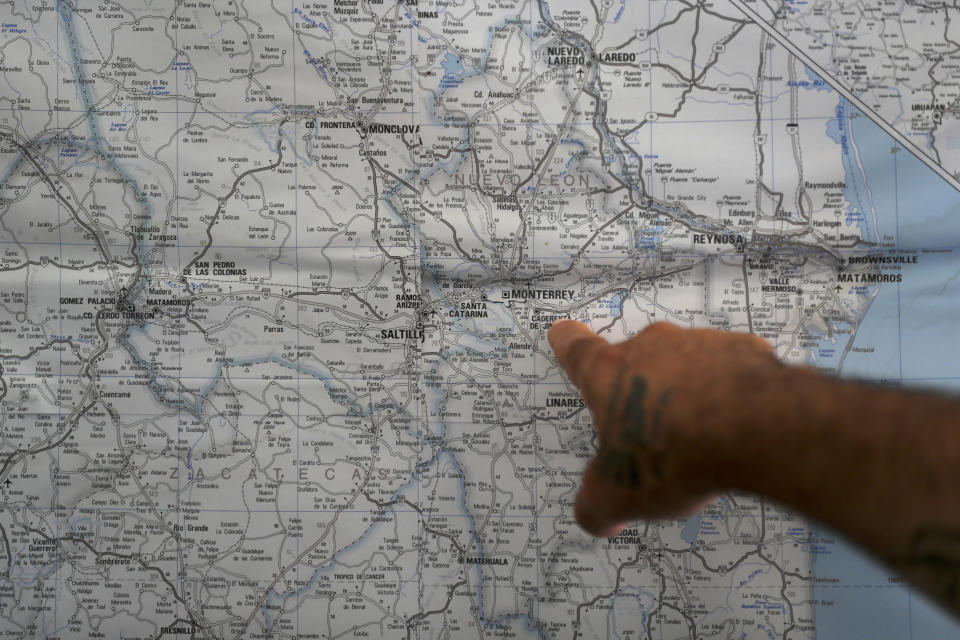 In this Oct. 10, 2019 photo, a Mexican migrant points to a map of U.S.-Mexico border cities, hanging on display at a migrant shelter in Reynosa, Mexico. The Mexican state of Tamaulipas used to be a crossroads. Its dangers are well known; the U.S. has warned its citizens to stay away, assigning it the same alert level as war-torn countries such as Afghanistan and Syria. (AP Photo/Fernando Llano)