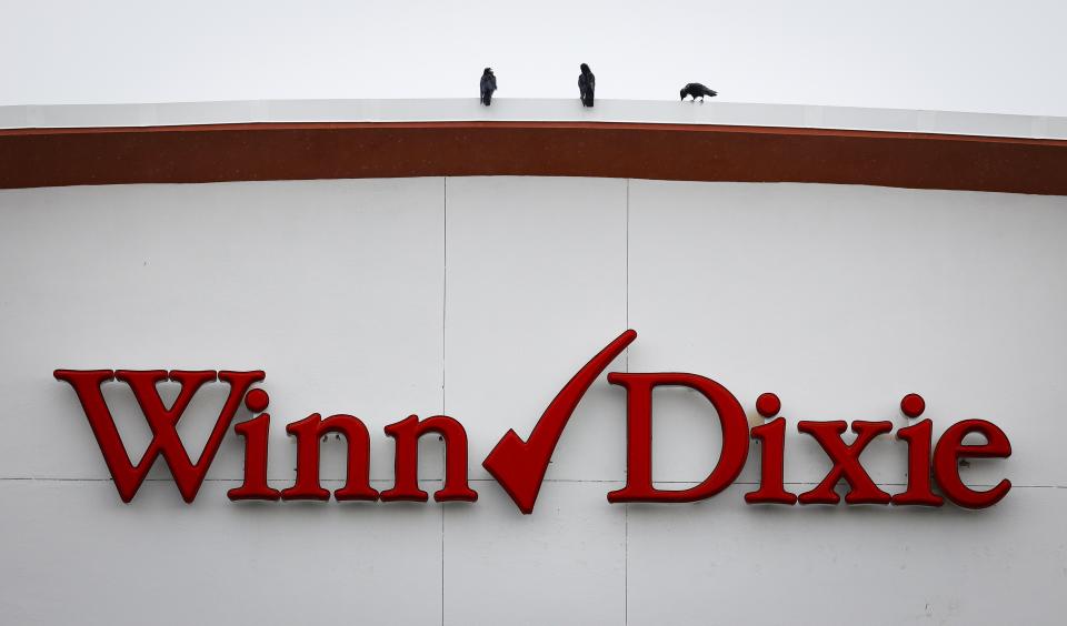 Birds are perched above the Winn Dixie sign at the Palm Harbor, Fla., store Wednesday, Aug. 16, 2023. Discount grocer Aldi said Wednesday it plans to buy 400 Winn-Dixie and Harveys supermarkets in the southern U.S. (Chris Urso/Tampa Bay Times via AP)