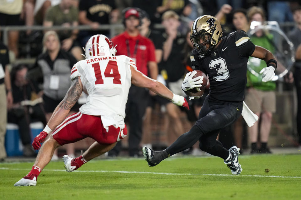 Purdue running back Tyrone Tracy Jr. (3) cuts around sWisconsin safety Preston Zachman (14) on his way to a touchdown during the second half of an NCAA college football game in West Lafayette, Ind., Friday, Sept. 22, 2023. (AP Photo/Michael Conroy)