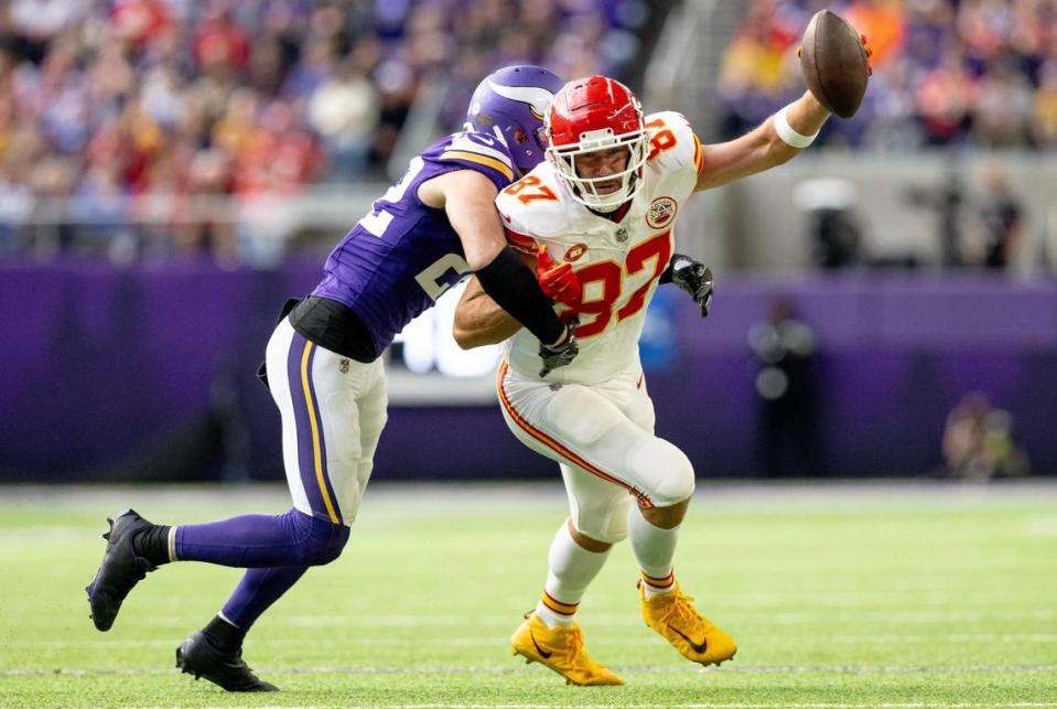 Kansas City Chiefs tight end Travis Kelce (87) tries to escape a tackle attempt by Minnesota Vikings safety <span class="caas-xray-inline-tooltip"><span class="caas-xray-inline caas-xray-entity caas-xray-pill rapid-nonanchor-lt" data-entity-id="Harrison_Smith" data-ylk="cid:Harrison_Smith;pos:4;elmt:wiki;sec:pill-inline-entity;elm:pill-inline-text;itc:1;cat:Athlete;" tabindex="0" aria-haspopup="dialog"><a href="https://search.yahoo.com/search?p=Harrison%20Smith" data-i13n="cid:Harrison_Smith;pos:4;elmt:wiki;sec:pill-inline-entity;elm:pill-inline-text;itc:1;cat:Athlete;" tabindex="-1" data-ylk="slk:Harrison Smith;cid:Harrison_Smith;pos:4;elmt:wiki;sec:pill-inline-entity;elm:pill-inline-text;itc:1;cat:Athlete;" class="link ">Harrison Smith</a></span></span> (22) during an NFL football game on Sunday, Oct. 8, 2023, at U.S. Bank Stadium in Minneapolis, Minn. Nick Wagner/nwagner@kcstar.com