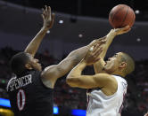 San Diego State forward Skylar Spencer (0) defends agasint Arizona guard Nick Johnson (13) during the first half of a regional semifinal in the NCAA men's college basketball tournament, Thursday, March 27, 2014, in Anaheim, Calif. (AP Photo/Mark J. Terrill)