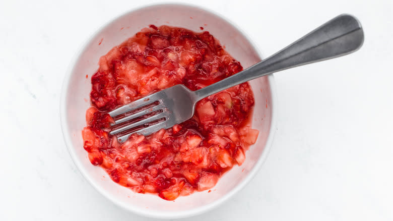 Mashed strawberries in a bowl