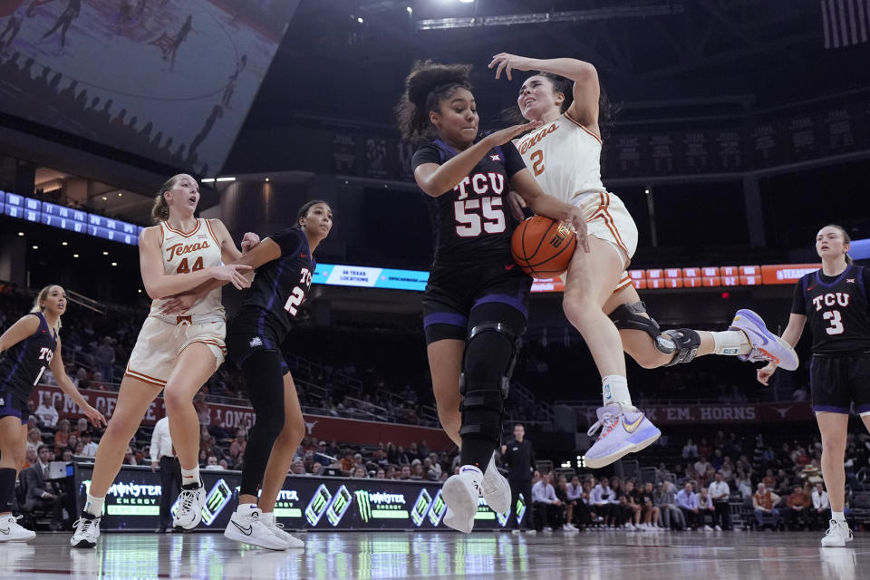Texas guard Shaylee Gonzales (2) loses control of the ball as she drives to the basket against TCU guard Victoria Flores (55) during the second half of an NCAA college basketball game in Austin, Texas, Wednesday, Jan. 10, 2024. (AP Photo/Eric Gay)