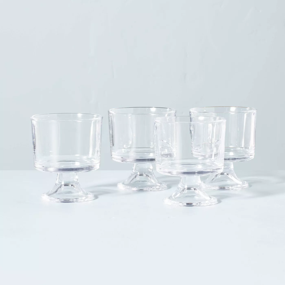 four glass parfait cups on blue backdrop