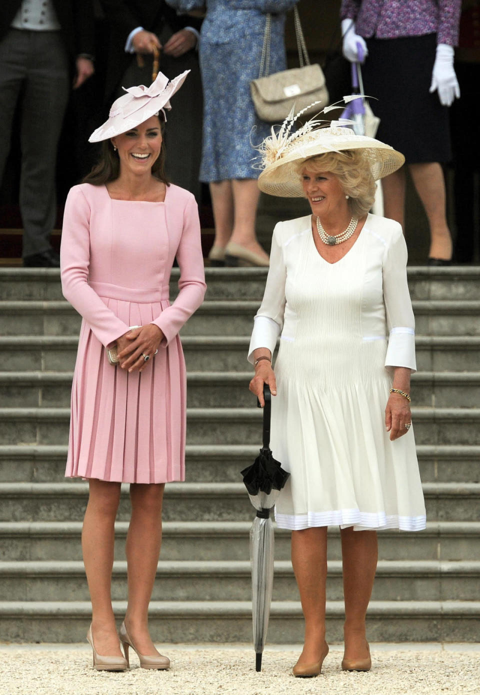 <p>Kate wore a familiar pink pleated dress by Emilia Wickstead for a garden party at Buckingham Palace. She accessorised with a wide-brimmed hat by Jane Corbett and donned a bag and heels from L.K. Bennett.</p><p><i>[Photo: PA]</i></p>