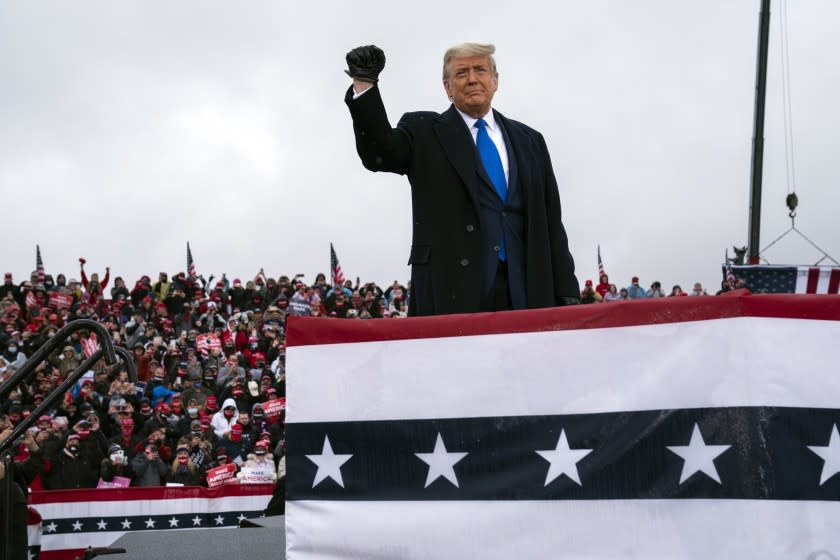 President Donald Trump arrives at Capital Region International Airport for a campaign rally, Tuesday, Oct. 27, 2020, in Lansing, Mich. (AP Photo/Evan Vucci)