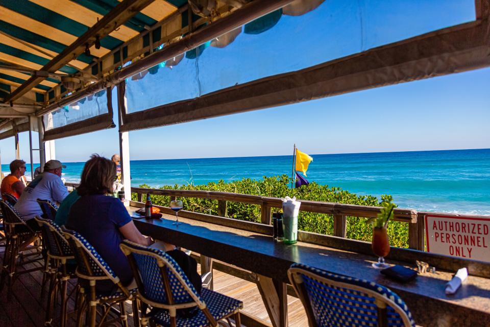 Wave watchers at the Dune Deck Café in Lantana.