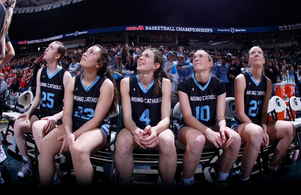 Lansing Catholic starters, from left, Morgan Wilcox, Gabby Halliwill, Hannah Pricco, Anna Richards and Leah Richards, await their introductions before their game against Frankenmuth, Saturday, March 18, 2023, in East Lansing.