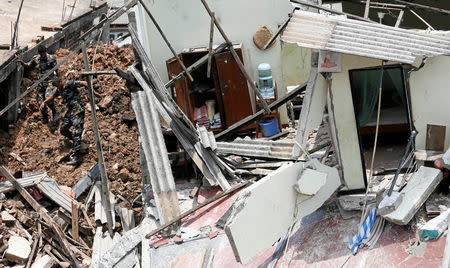 Members of the military work during a rescue mission after a garbage dump collapsed and buried dozens of houses in Colombo, Sri Lanka April 16, 2017. REUTERS/Dinuka Liyanawatte