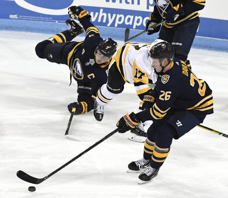 Buffalo Sabres center Jack Eichel (9) falls to the ice as Pittsburgh Penguins' Bryan Rust (17) goes after a puck controlled by Sabres' Rasmus Dahlin (26) during t an NHL preseason hockey game, Monday, Sept. 16, 2019, in State College, Pa. (AP Photo/John Beale)