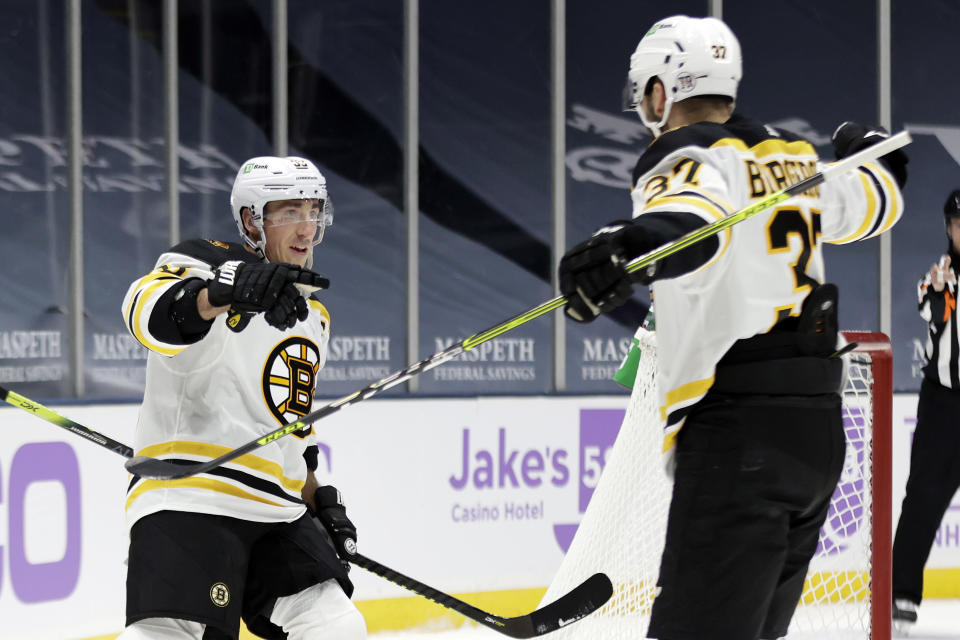 Boston Bruins center Brad Marchand reacts after scoring a goal against the New York Islanders during the first period of an NHL hockey game Saturday, Feb. 13, 2021, in Uniondale, N.Y. (AP Photo/Adam Hunger)