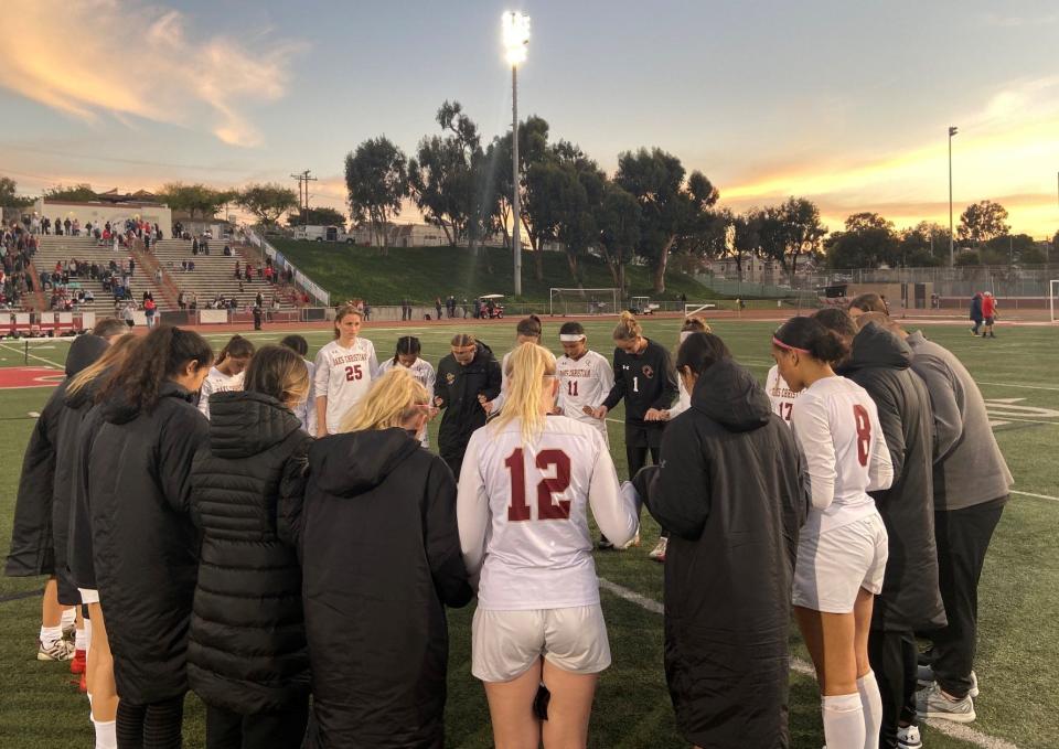 The Oaks Christian girls soccer team prays together after losing to host Redondo Union 3-0 in the CIF-SS Division 2 final on Saturday.