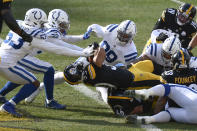 Pittsburgh Steelers running back James Conner (30) twists over the goal line for a touchdown as Indianapolis Colts defensive tackle DeForest Buckner (99), outside linebacker Darius Leonard (53) and free safety Julian Blackmon (32) defend during the first half of an NFL football game, Sunday, Dec. 27, 2020, in Pittsburgh. (AP Photo/Don Wright)