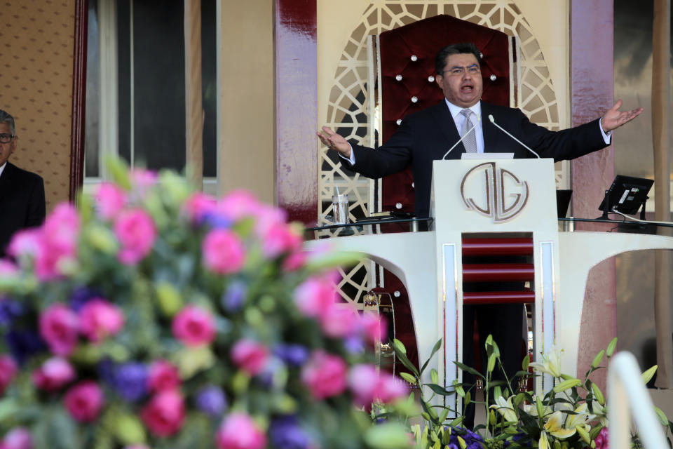 ADDS FIRST NAME - In this Aug. 9, 2018 photo, Naasón Joaquín García leads a service at his church "La Luz del Mundo" in Guadalajara, Mexico. Garcia, the leader and self-proclaimed apostle of La Luz del Mundo, a controversial church that claims over 1 million followers, has been charged with human trafficking and child rape, California authorities said on Tuesday, June 4, 2019. (AP Photo)