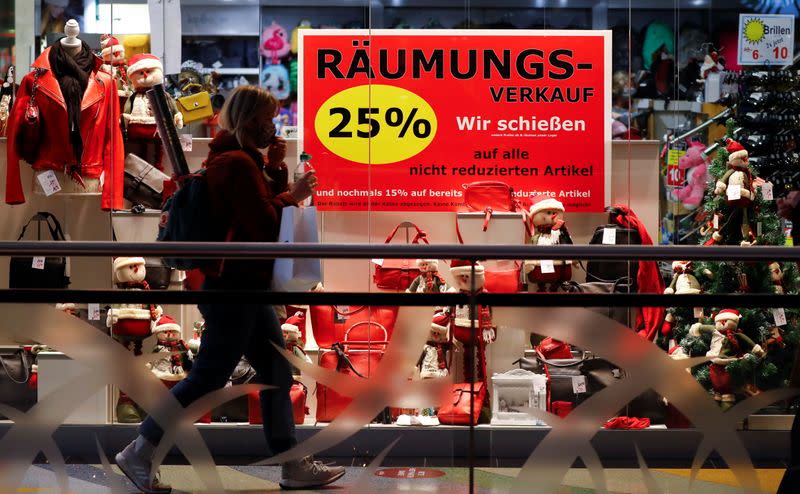 FILE PHOTO: A woman walks past a shop window with a Christmas theme amid the coronavirus disease (COVID-19) outbreak in Berlin