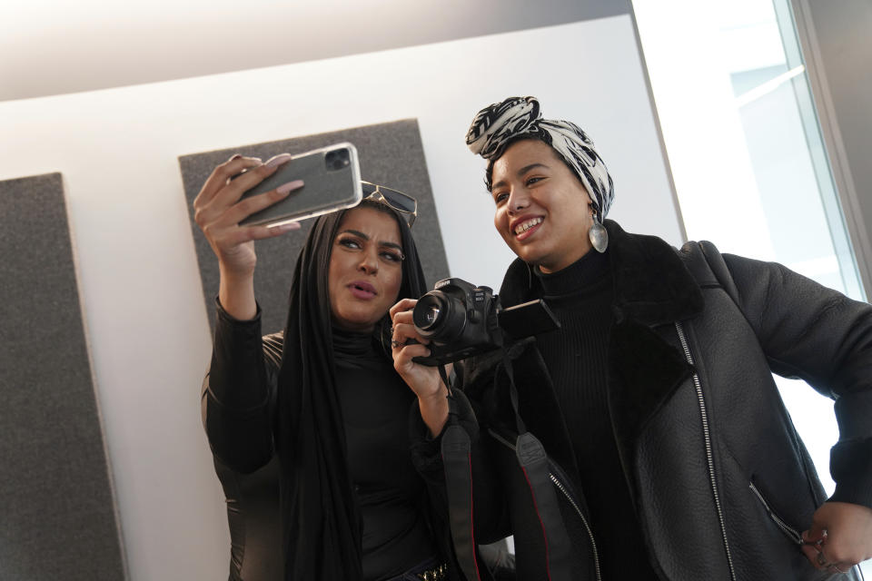 In this Dec. 19, 2019, photo, Amani Al-Khatahtbeh, left, films a video with Maryam Saad after recording a podcast pilot at Spotify's headquarters in New York. Al-Khatahtbeh started the website as a way to defy Muslim stereotypes after 9/11. A decade later, Al-Khatahtbeh has built it into an online magazine with a global audience. (AP Photo/Emily Leshner)