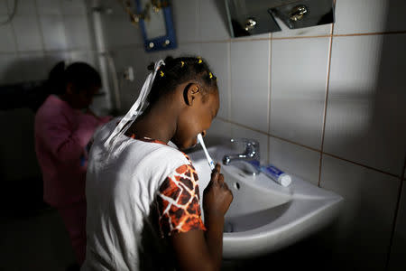 Girls brush their teeth after they woke up at an orphanage in Sanaa, Yemen, December 26, 2016. REUTERS/Khaled Abdullah