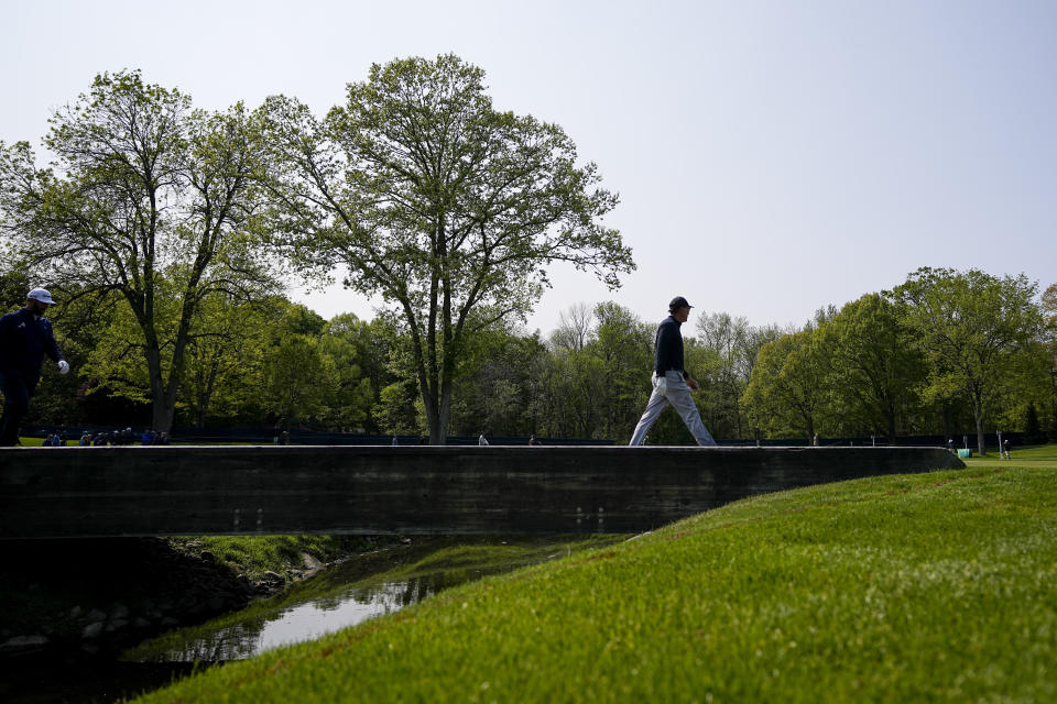 Phil Mickelson walks across the bridge on the seventh hole during a practice round for the PGA Championship golf tournament at Oak Hill Country Club on Wednesday, May 17, 2023, in Pittsford, N.Y. (AP Photo/Eric Gay)