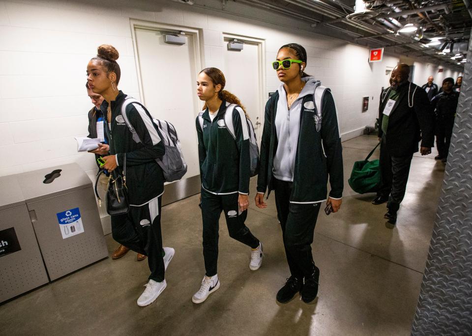 Mila Reynolds (15), from left, Amiyah Reynolds (1) and Kira Reynolds (11) walk to their locker room before the Washington vs. Silver Creek girls state championship basketball game Saturday, Feb. 26, 2022 at Gainbridge Fieldhouse in Indianapolis. 