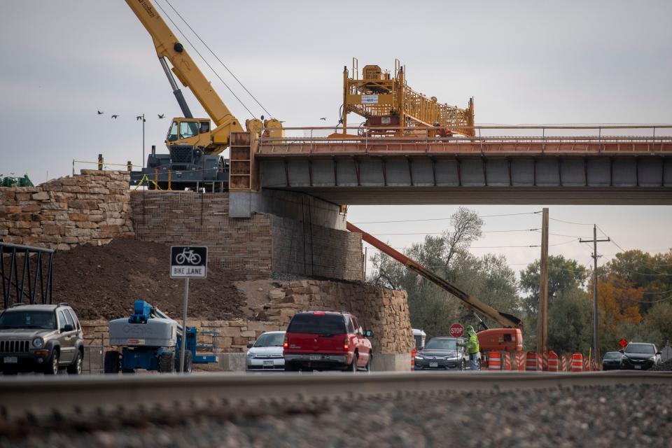 Traffic moves under an overpass during construction on Vine Street between Lemay Avenue and Timberline Road in October.