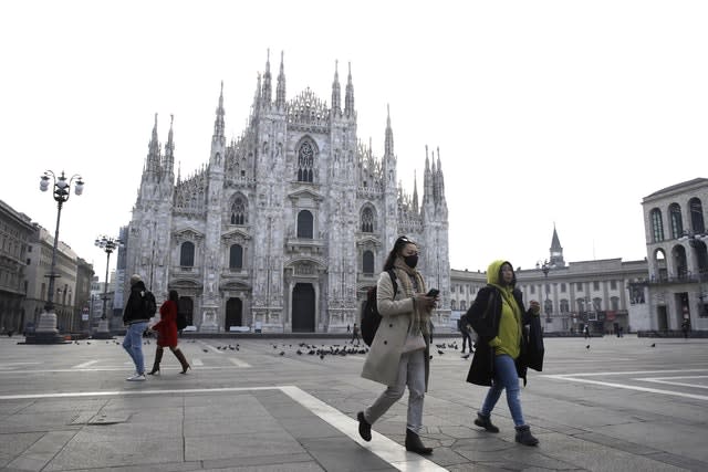 Tourists outside the Duomo Gothic cathedral in Milan, Italy