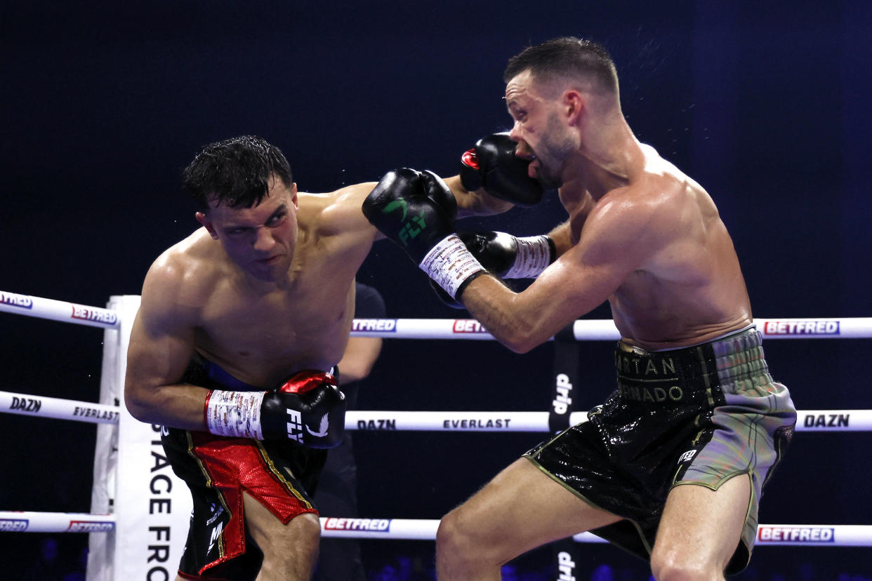 Jack Catterall, left, punches Josh Taylor in the super lightweight boxing bout at the First Direct Arena in Leeds, Britain, Saturday, May 25, 2024. (Richard Sellers/PA via AP)