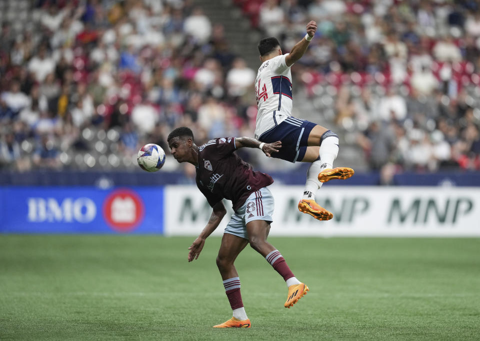 Colorado Rapids' Max, left, and Vancouver Whitecaps' Luis Martins vie for the ball during the first half of an MLS soccer match Saturday, April 29, 2023, in Vancouver, British Columbia. (Darryl Dyck/The Canadian Press via AP)