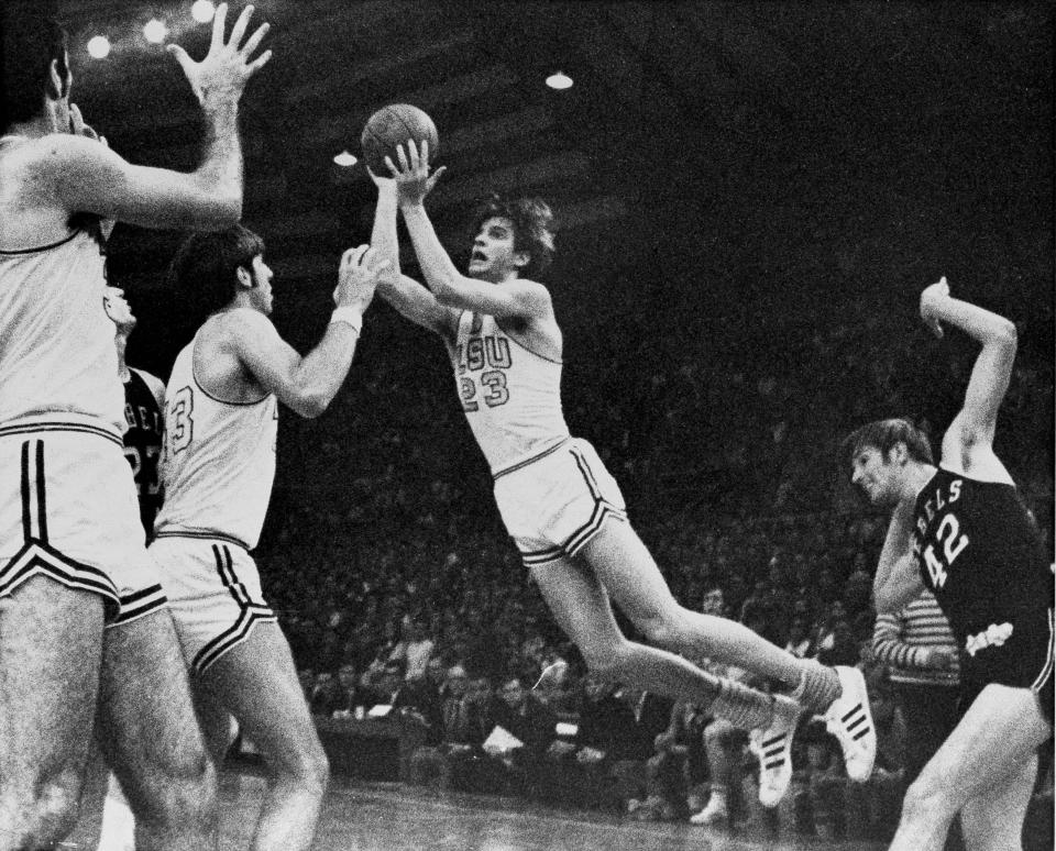 FILE - Louisiana State's Pete "Pistol" Maravich (23) flies through the air during record breaking performance against Mississippi in Baton Rouge, La., Feb. 1, 1970, to become college basketball's leading scorer of all-time. At right is University of Mississippi's Tom Butler (42) and at left are LSU's Danny Hester (35) and Bill Newton (43). In the 1969-70 season, Maravich produced a season at LSU that may never be matched. (AP Photo/File)