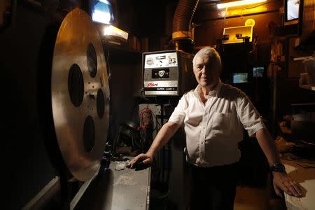 Maurice Laroche, owner of Le Beverley adult cinema, poses inside the projection room at his cinema in Paris July 30, 2014. REUTERS/Christian Hartmann