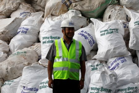 A man stands in front of the garbage collected and brought from Mount Everest to recycle in Kathmandu