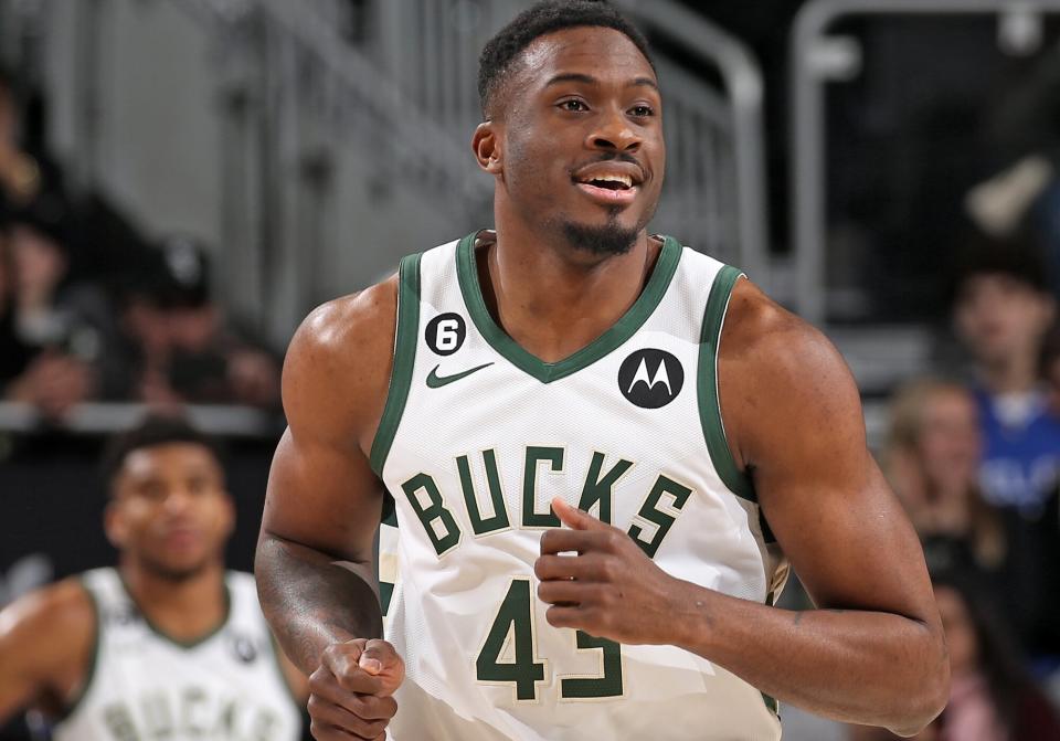 Thanasis Antetokounmpo #43 of the Milwaukee Bucks runs up the court while brother Giannis Antetokounmpo #34 looks on from the bench during the game against the New Orleans Pelicans on January 29, 2023 at the Fiserv Forum Center in Milwaukee, Wisconsin.