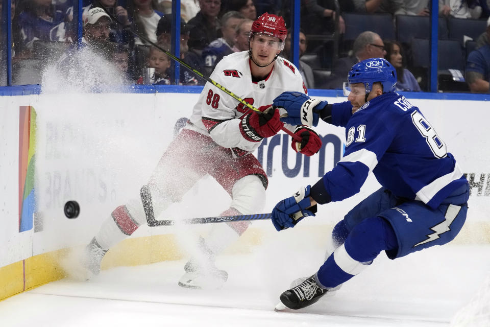 Carolina Hurricanes center Martin Necas (88) flips the puck past Tampa Bay Lightning defenseman Erik Cernak (81) during the first period of an NHL hockey game Tuesday, Oct. 24, 2023, in Tampa, Fla. (AP Photo/Chris O'Meara)