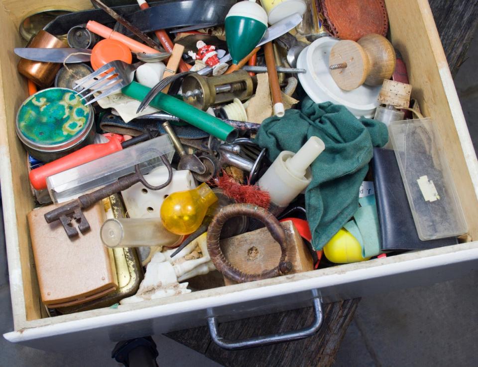 A junk drawer full of eclectic household items. 