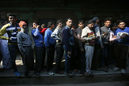 Voters stand in queue to cast their votes at a polling station during the state assembly election in New Delhi February 7, 2015. REUTERS/Anindito Mukherjee/File Photo